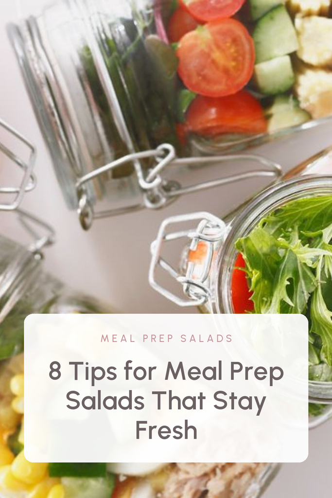 Mason jars of layered salad with tomatoes and greens, the photo filling the pin, with a white text panel low in the frame reading "8 Tips for Meal Prep Salads That Stay Fresh". Label: Meal Prep Salads.